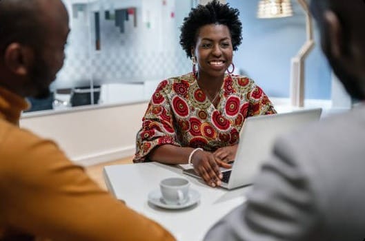 Consultant meeting clients at a laptop